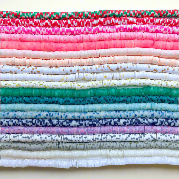 Stack of speckled heishi bead options in a rainbow pattern on a white background