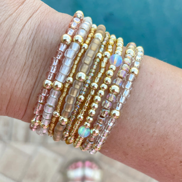 Stack of beaded bracelets on a wrist with a blurred background