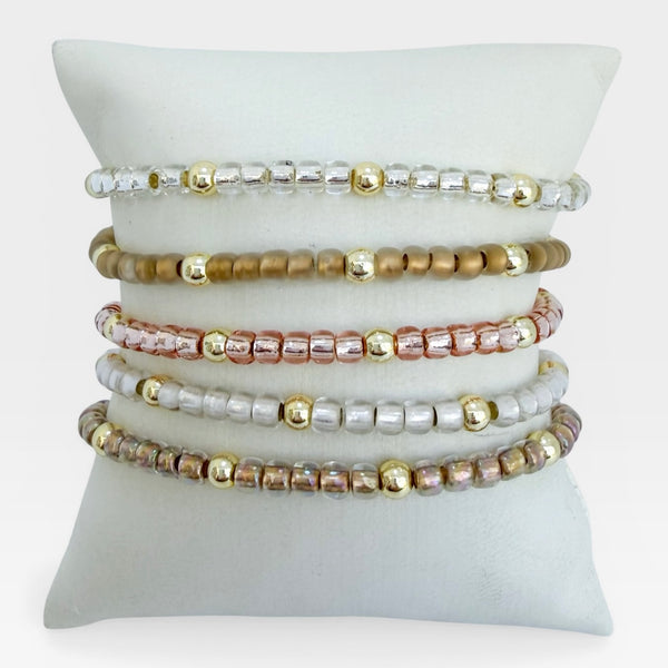 Set of beaded bracelets on a white cushion