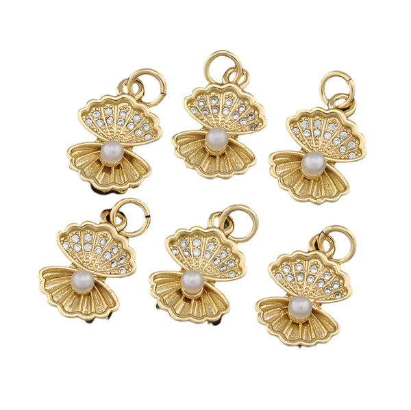 Gold clamshell pendants with pearl centers on a white background