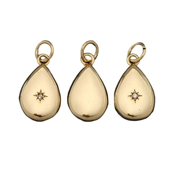 Three gold teardrop-shaped pendants with star designs on a white background