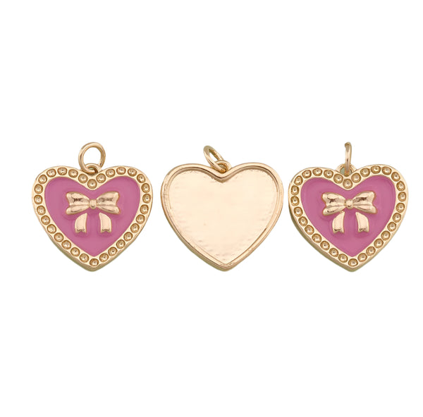 Three heart-shaped pendants with pink enamel and gold accents on a white background