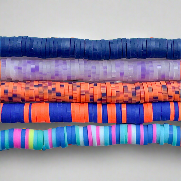 MIscellaneous heishi beads stacked on a white background