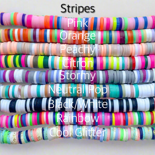 Stack of colorful striped heishi beads with labels on a white background
