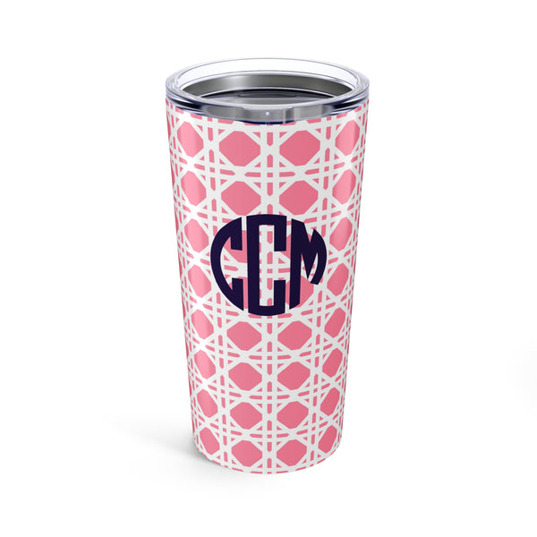 Tumbler with light pink rattan caning pattern and navy monogram on a white background