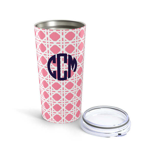 Tumbler with light pink rattan caning pattern and navy monogram on a white background