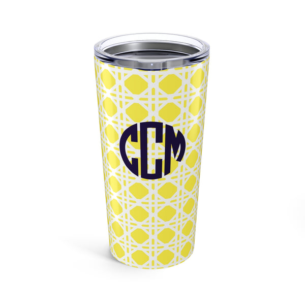 Tumbler with yellow rattan caning pattern and navy monogram on a white background