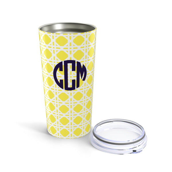 Tumbler with yellow rattan caning pattern and navy monogram on a white background