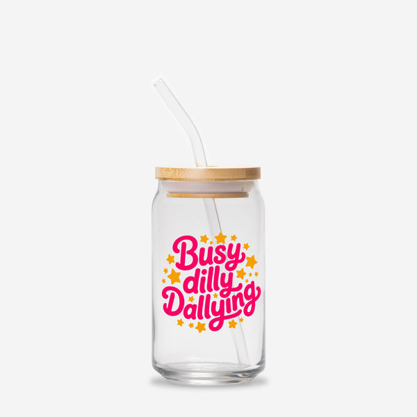 Glass jar with straw and wooden lid featuring 'Busy dilly Dallying' text on a white background