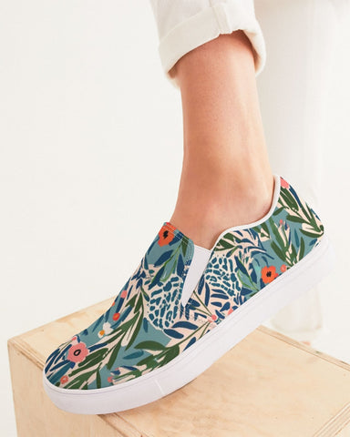 Jungle patterned slip-on sneakers on a foot on white background