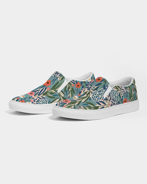 Pair of slip-on shoes with floral jungle pattern on a white background
