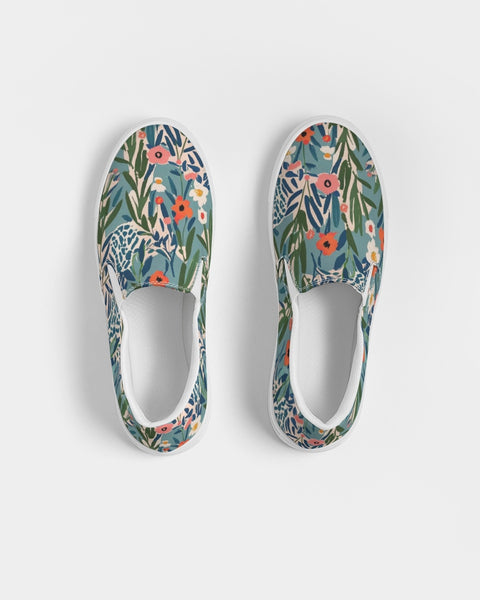 Pair of slip-on shoes with floral jungle pattern on a white background
