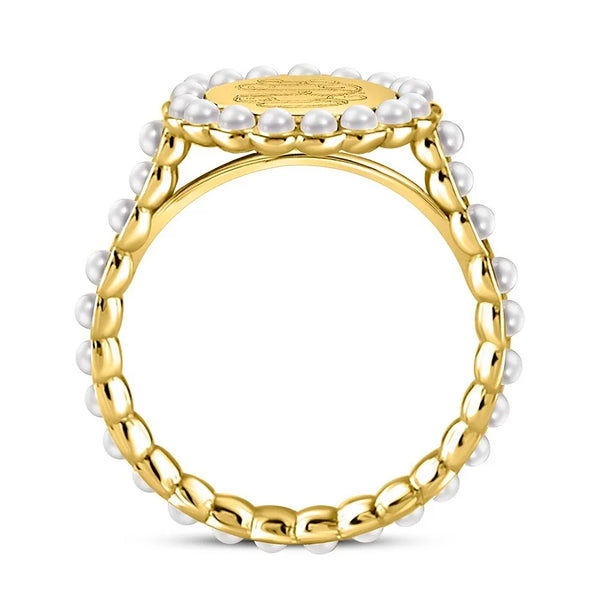 A gold signet ring decorated with small white pearls around the face and along the twisted band, shown on a clean white background.