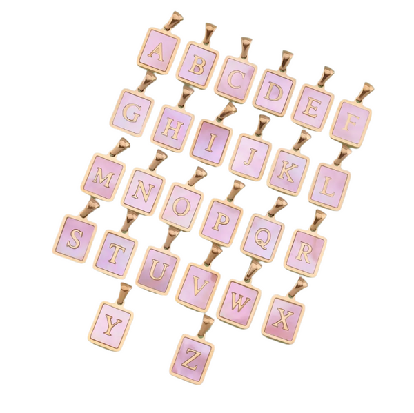 Pink mother of pearl alphabet letter pendants on a white background