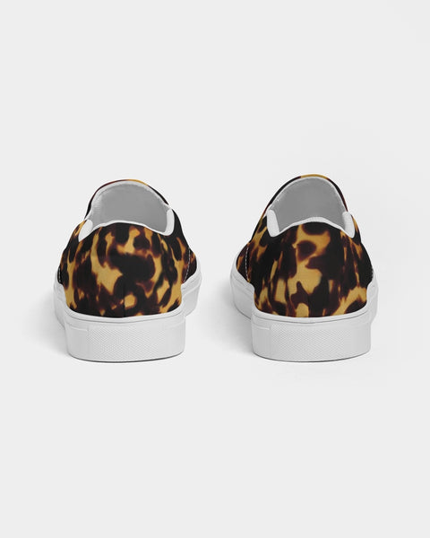 Tortoiseshell print slip-on sneakers with white soles on a light gray background