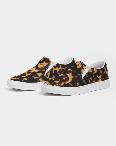 Tortoiseshell print slip-on sneakers with white soles on a light gray background