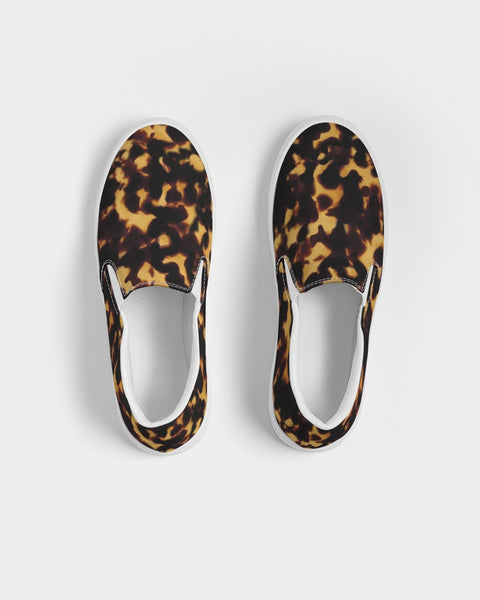 Pair of Tortoiseshell print slip-on shoes on a light gray background