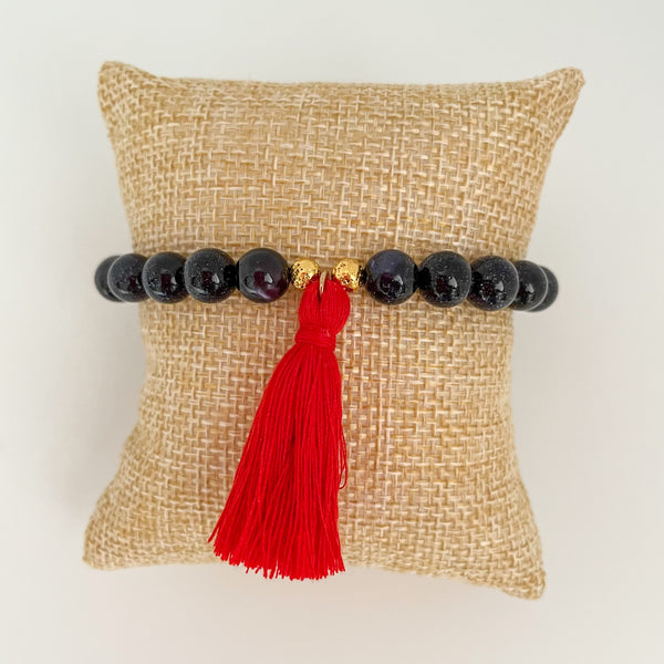 handmade goldstone tassel bracelet with red tassel