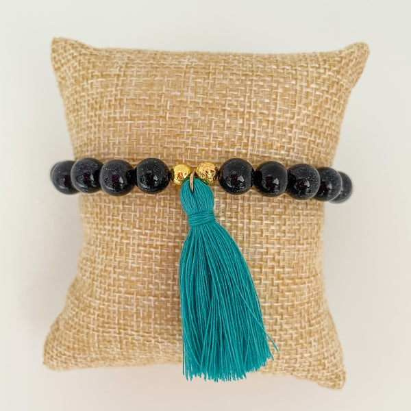 handmade goldstone tassel bracelet with teal tassel